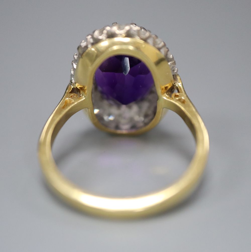 A 1970s 18ct gold, amethyst and diamond set oval cluster dress ring, size Q, gross 7.8 grams.